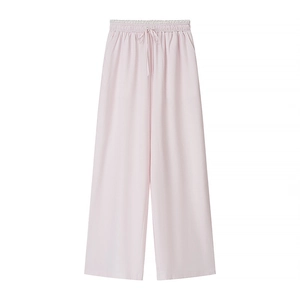 Detail of pink wide-leg pants featuring drawstring waist and delicate lace trim accents