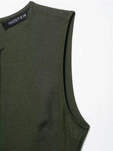 Macro view of olive green linen texture and inner neckline tag on sleeveless dress