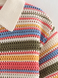 Close-up of crochet knit polo shirt with colorful stripes and open-work pointelle texture