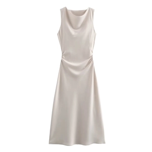 Detail of elegant champagne satin dress featuring a cowl neck and side ruching texture