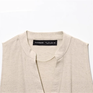 Beige slim fit sleeveless dress with V-neckline detail and a subtle metallic chain