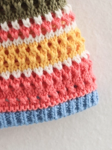 Close-up of multicolor crochet polo set showing hollow-out knit texture and ribbed hem