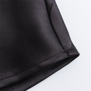 Detail view of the high-quality double stitching on black satin silk dress fabric