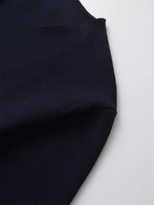 Macro shot of dark blue knit fabric with precise stitch texture and clean finished edges