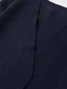 Detailed view of dark blue knit fabric with focus on clean stitching and seam quality