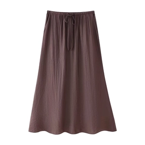 Detail of high waist A-line maxi skirt with elastic drawstring and pleated texture