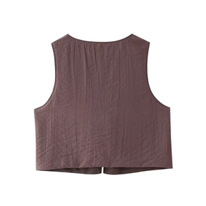 Detail of dark brown pleated fabric texture on a sleeveless summer vest for women