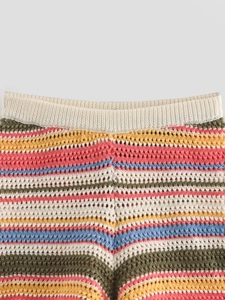 Close-up of bohemian crochet knit texture and colorful striped waist details