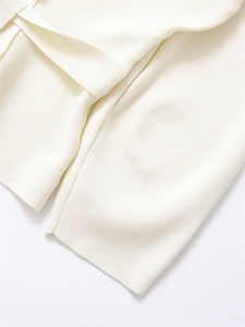 Detail shot of the high-quality white knit fabric texture and premium stitching on the garment