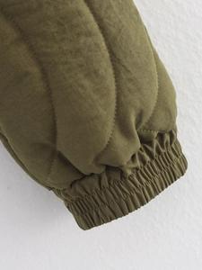 Gros plan sur les poignets élastiques matelassés vert armée de cette veste d'hiver