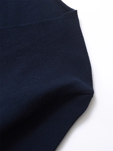Detailed macro view of the premium navy blue ribbed knit texture and stitching quality