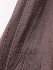 Detailed close-up of brown vertical pleated fabric with high-quality woven texture