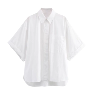 Detail of white short sleeve shirt featuring front pocket and hidden button placket