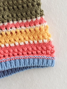 Detailed macro view of multicolor crochet knit texture with striped pattern design
