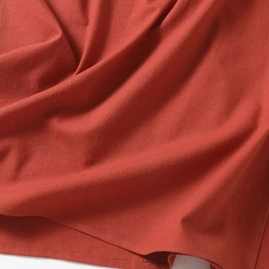 Detailed macro view of red fabric texture with professional double-stitched hem finish