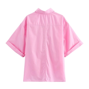 Detail view of pink short sleeve shirt back with drop shoulder and cuffed sleeves