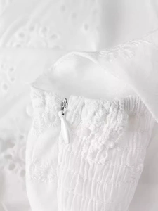 White eyelet embroidery summer dress featuring smocking details and invisible zipper back