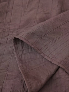Detail view of coffee brown vertical stripe texture and sewing quality on a summer skirt set