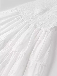 White eyelet embroidery V-neck backless dress featuring elegant smocked waist and layered ruffles