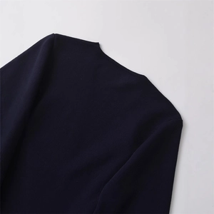 Navy blue V-neck knit jacket with shoulder pads and waist belt detail view