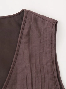 Detail of deep brown pleated fabric texture and stitching on summer vest and skirt set