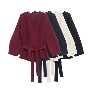 Women's deep V-neck knit top with shoulder pads and waist belt in four classic colors