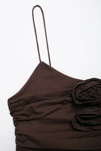Detail of coffee brown camisole featuring a large 3D fabric flower and thin straps