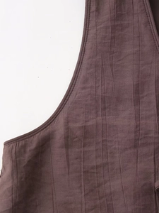 Detail of dark brown tank top featuring vertical micro-pleat texture and clean stitching