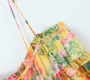 Detailed view of floral print dress with ruffle trim and thin spaghetti strap ties