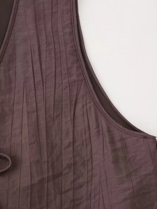 Detail shot of deep brown pleated fabric texture with high-quality inner lining