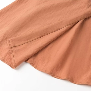 Detail of V-neck maxi dress hemline featuring premium cotton linen fabric and neat stitching