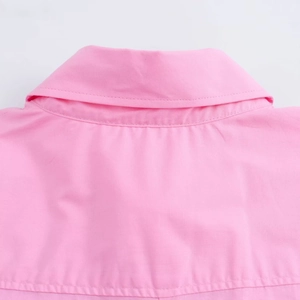 Detailed close-up of the collar stitching and woven fabric on the pink short sleeve shirt