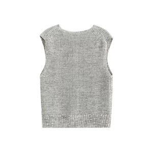 Close-up of gray knit vest showing refined texture and ribbed hem details