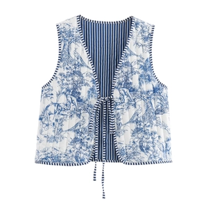 Detail of quilted vest showing blue toile de jouy print and front ribbon ties