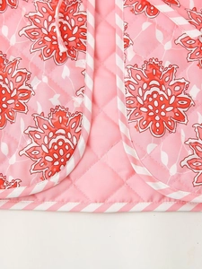 Summer pink floral quilted vest with classic diamond stitching and striped binding