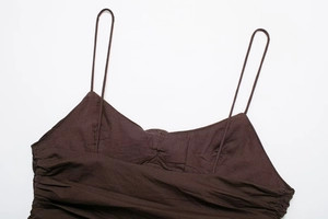 Close-up of chocolate brown camisole with thin straps and elegant ruched texture details