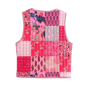 Detailed back view of a colorful patchwork quilted vest with floral patterns and textures