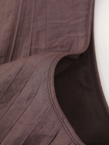 Detail of burgundy textured fabric with professional double stitching on the hem