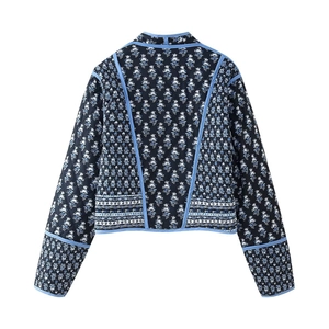 Detail of Y2K vintage floral quilted jacket showing blue contrast piping and fabric texture