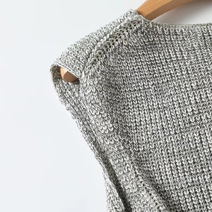 Detailed close-up of the grey ribbed knit texture and shoulder seam on a sleeveless vest