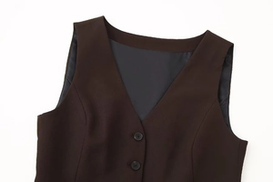 Close-up of dark brown V-neck vest showing premium woven fabric and black buttons