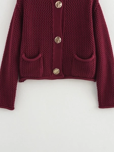 Women's burgundy chunky knit cardigan with gold buttons and front pockets