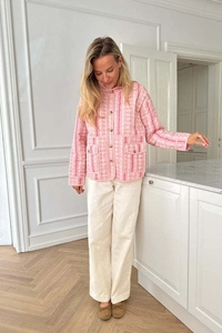 Detail of pink floral quilted jacket with single-breasted buttons and front pockets