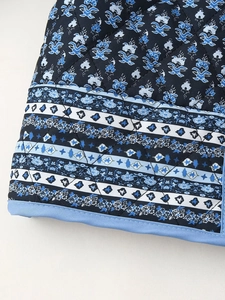Close-up of quilted diamond stitching and colorful floral vintage patterns on sleeve cuff