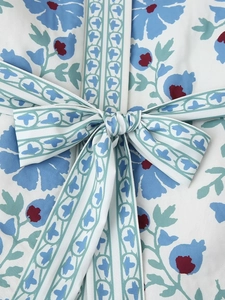 Women's fashion blue floral cotton coat with waist tie and bow detail close-up