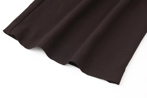 Detailed macro view of heavy-weight dark brown twill fabric with smooth stitching