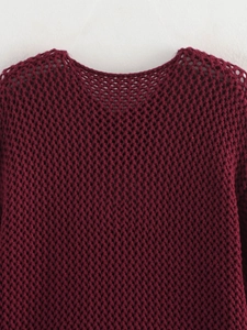Detailed macro shot of the burgundy hollow-out crochet knit texture and neckline