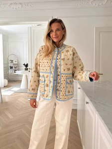 Women floral quilted cotton jacket with blue trim and button closure in a loose fit