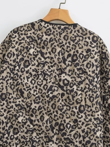Detail of leopard print cotton jacket featuring quilted texture and black collar trim