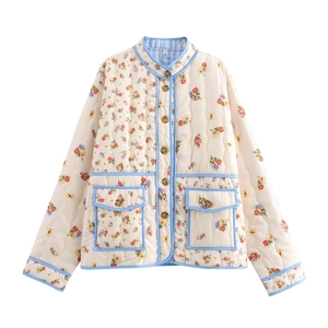 Detailed close-up of quilted floral jacket featuring light blue piping and front pockets